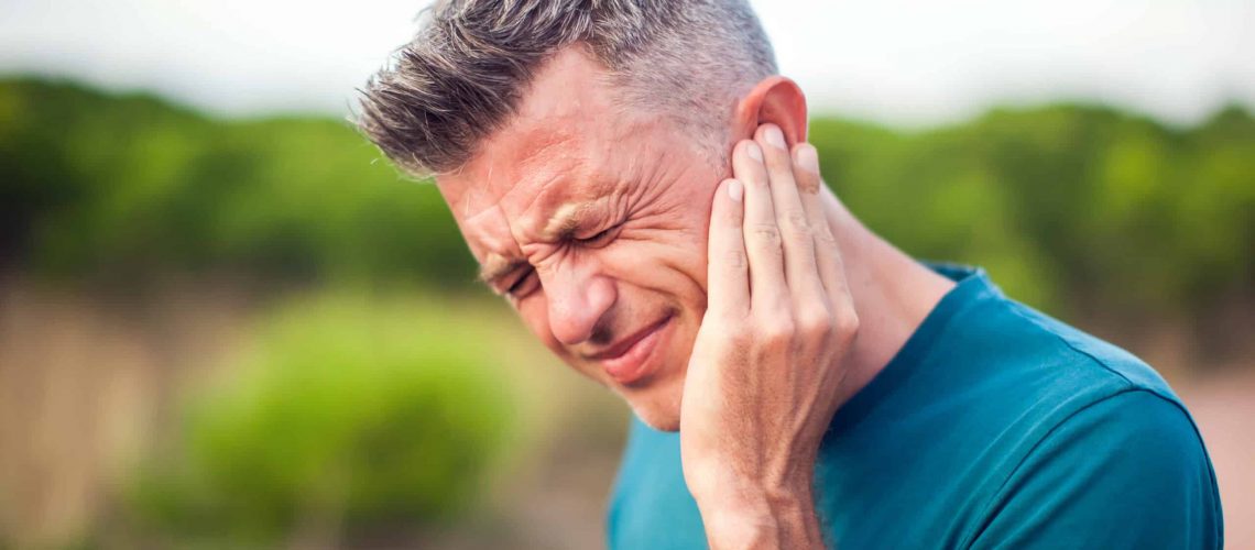 Ear,Pain.,Man,With,Otitis,Outdoor.,Healthcare,And,Medicine,Concept