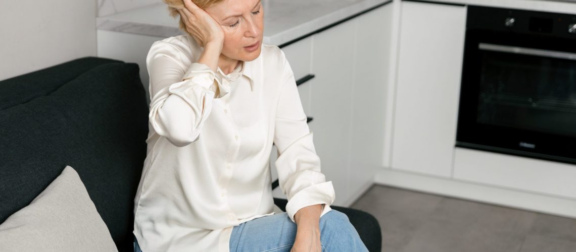 Senior,Woman,Experiencing,Headache,And,Ear,Ringing